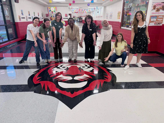 UGA students pose in the main hall of Bay Creek Elementary School.